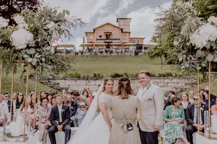 Hochzeitsfotograf Bayern Hochzeitszeremonie im Freien vor einem malerischen Bauernhaus Dokumentarische Editorial Hochzeitsfotografie