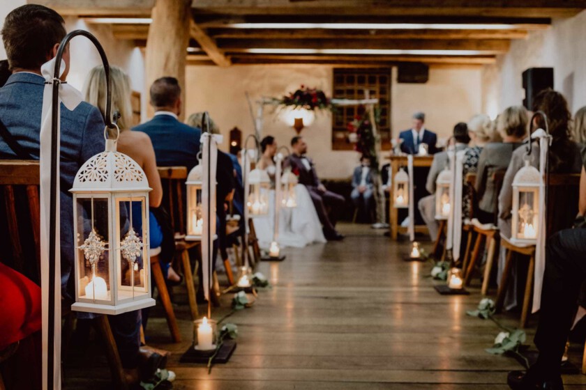 Lichterdekoration zur Trauung des Brautpaars. Schärfe im Bild liegt auf Kerze im Vordergrund.